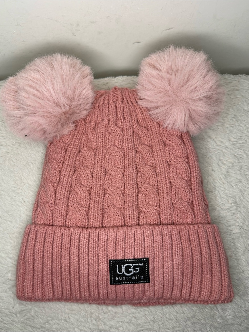 UGG Kids Blush Pink Cable Knit Hat with Dual Faux-Fur Poms